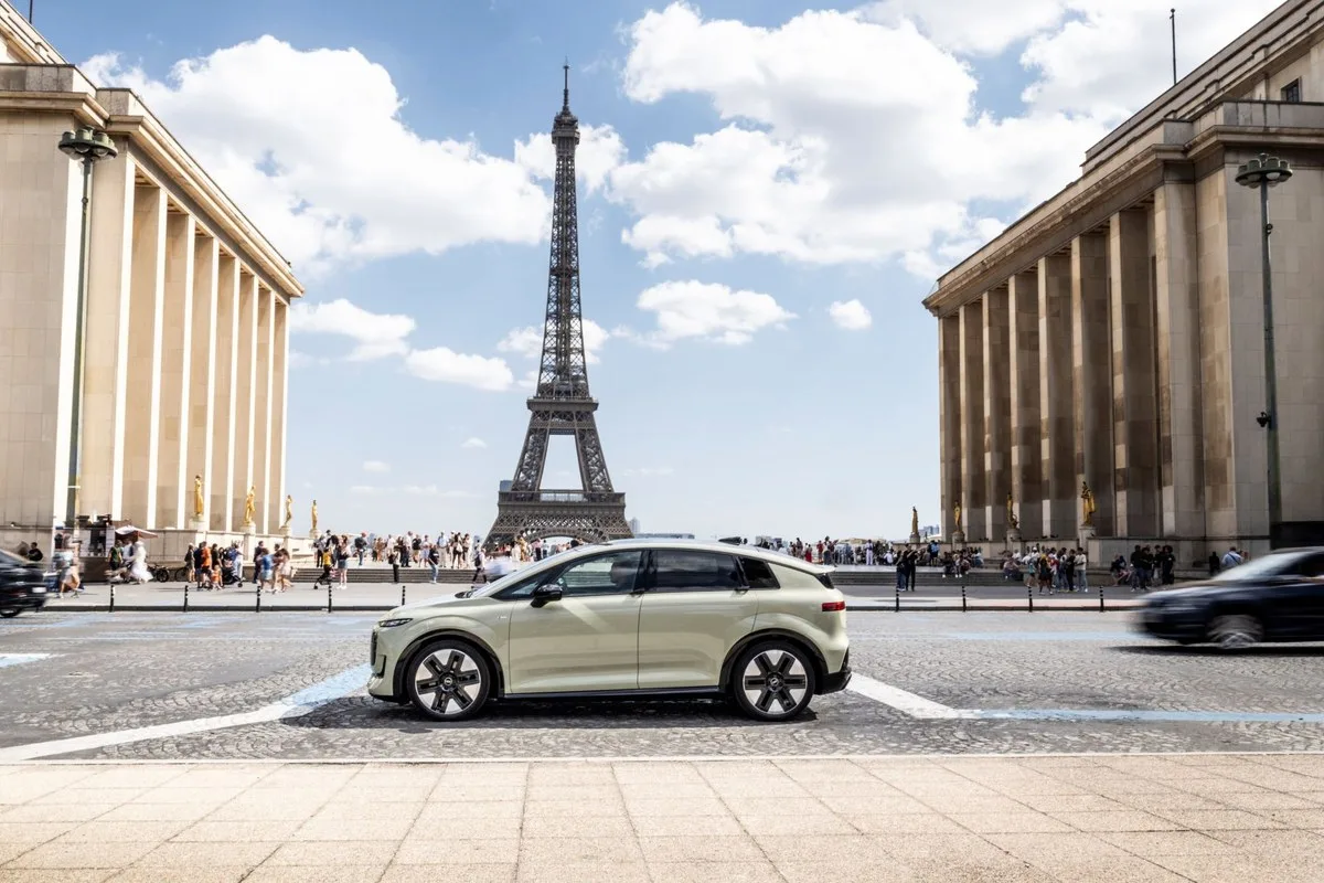 Audi A2 e-tron in pale green parked side-on at the Trocadero with the Eiffel Tower behind it