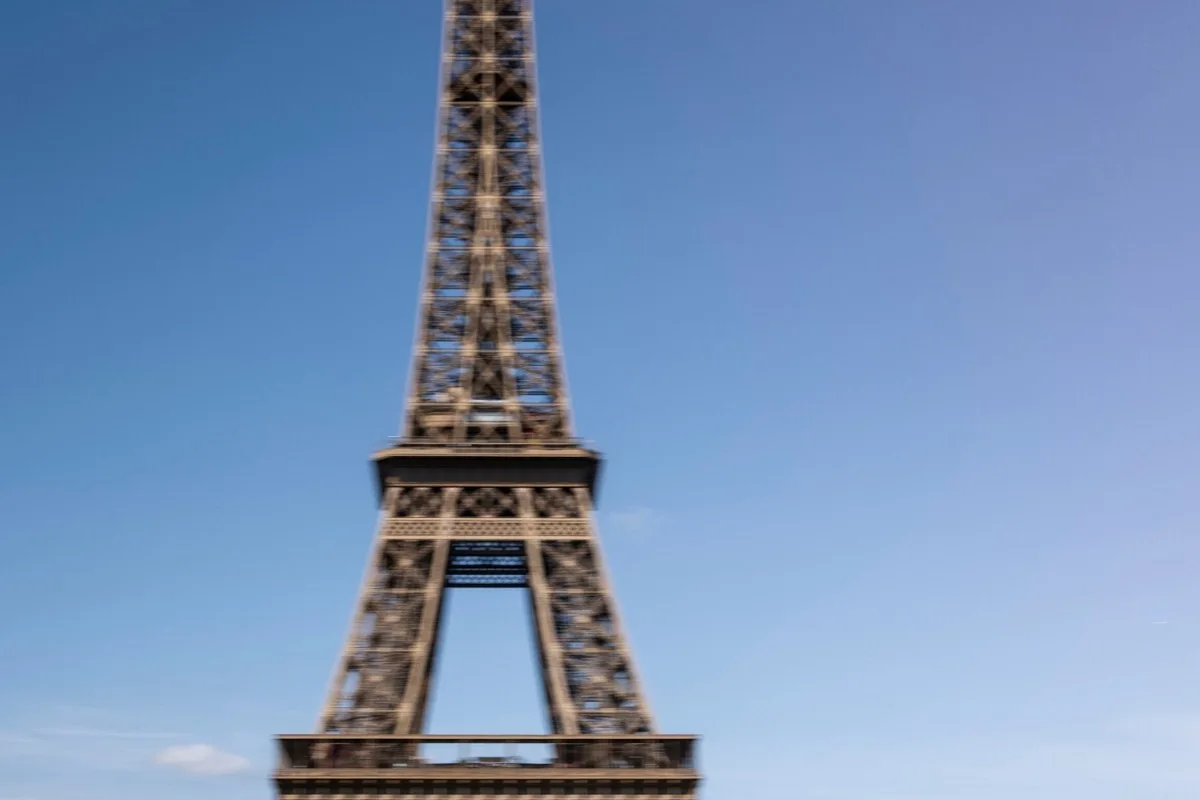 Audi A2 e-tron driving past the Eiffel Tower
