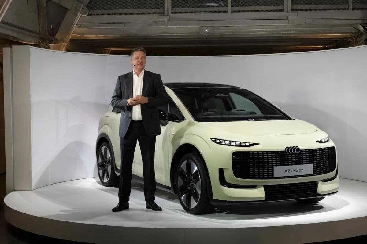 Audi CEO Gernot Dollner standing beside the Audi A2 e-tron on the launch stand