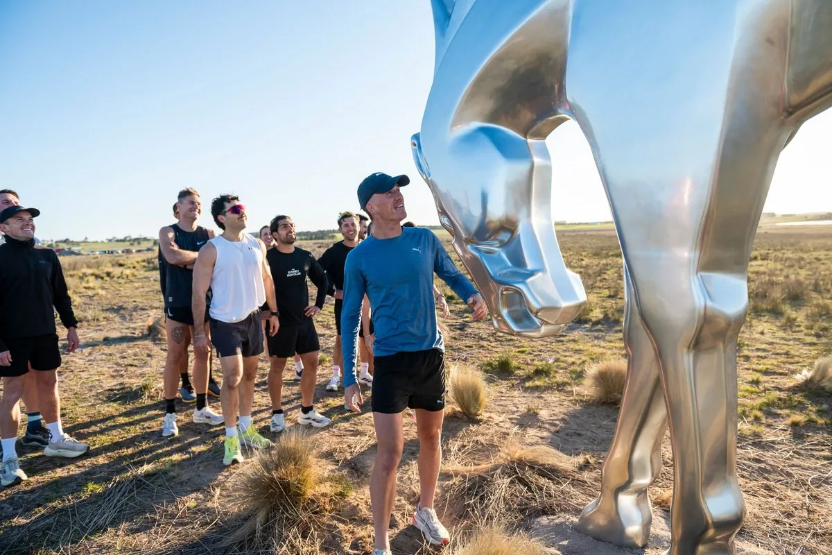 Nedd Brockmann and a group of runners gathered at the base of the chrome horse sculpture