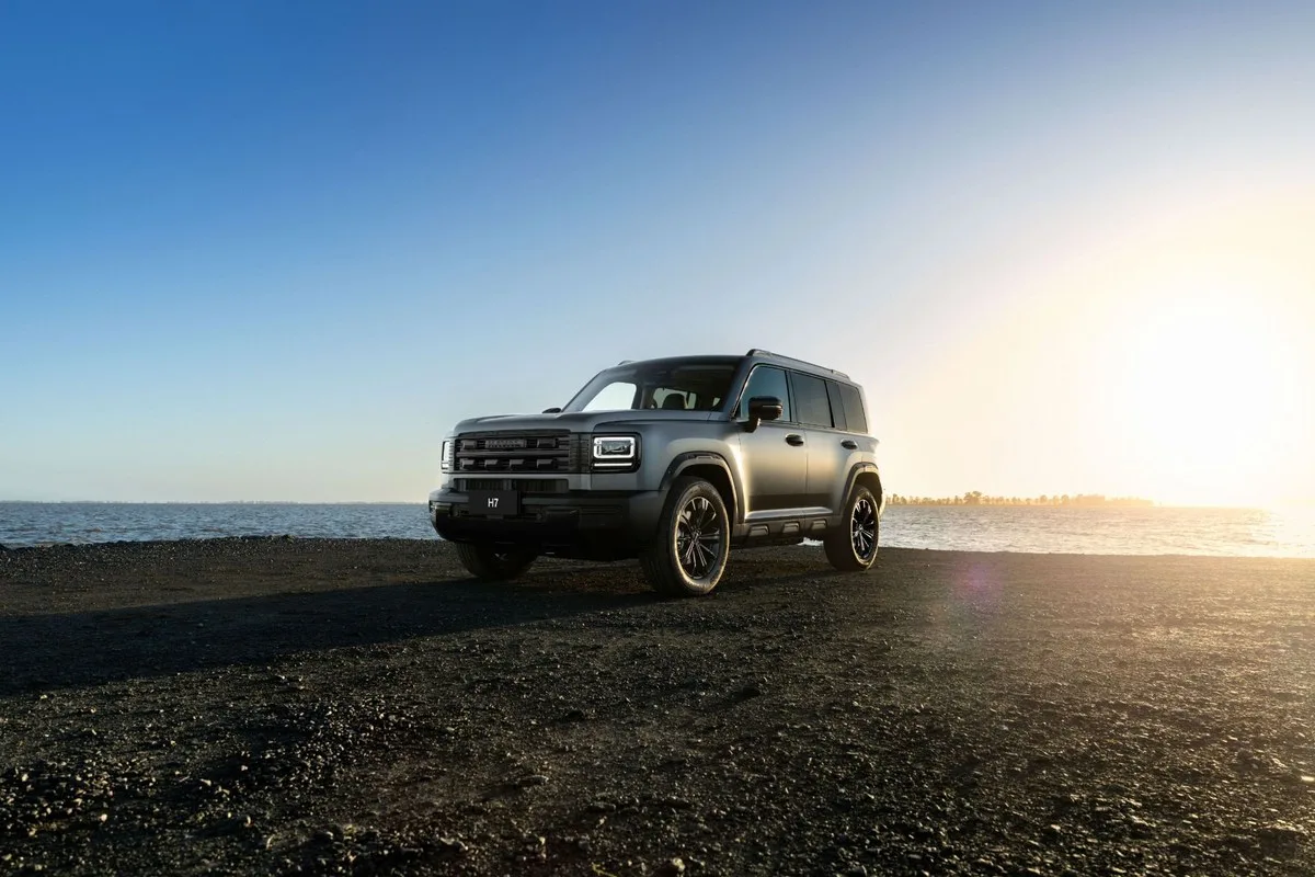 GWM Haval H7 parked on a stony shoreline at sunset