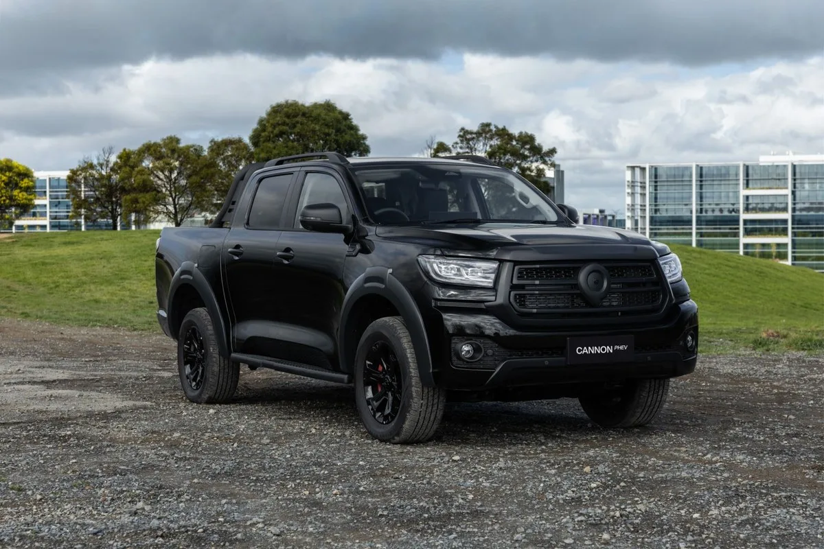 Black GWM Cannon Hi4-T PHEV dual-cab ute parked on gravel