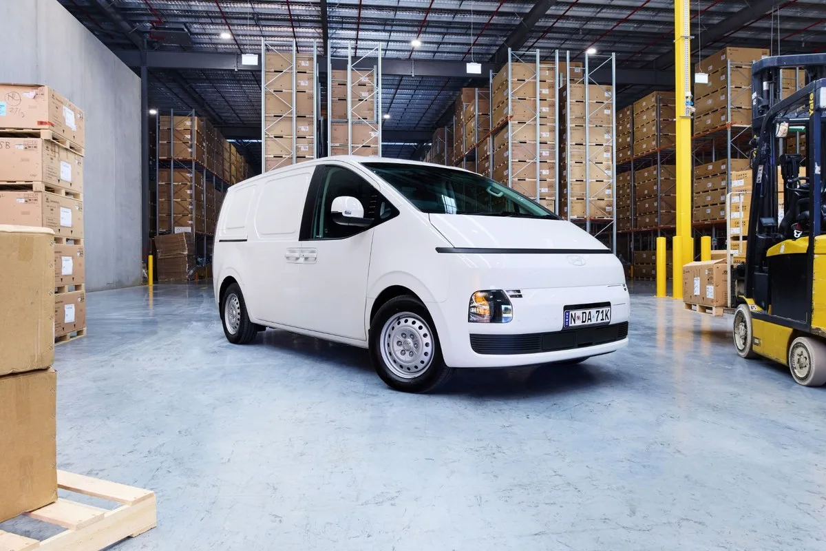 White Hyundai Staria Load Electric van in a warehouse, front three-quarter view