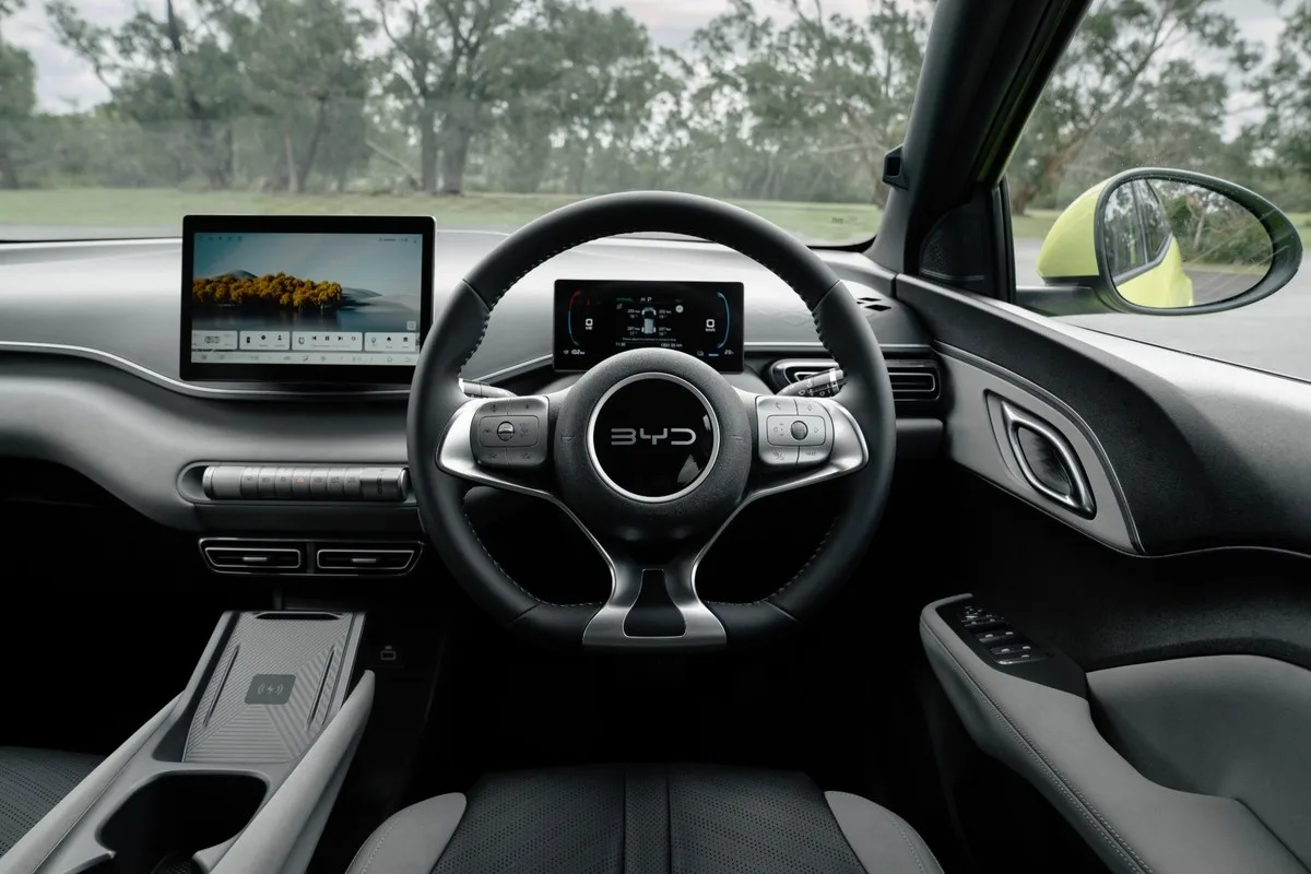 BYD ATTO 1 interior with the steering wheel, driver display and centre touchscreen.