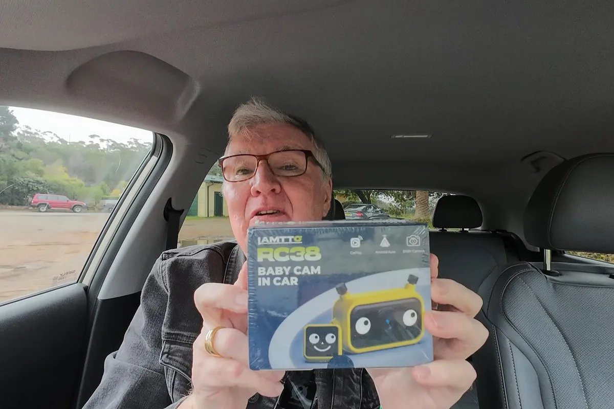 Alan Zurvas holding the boxed Lamtto RC38 baby cam in a car