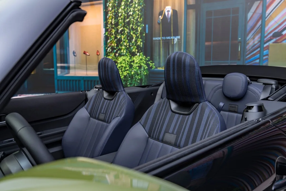 Navy striped knitted cloth and vegan leather seats with a Paul Smith label