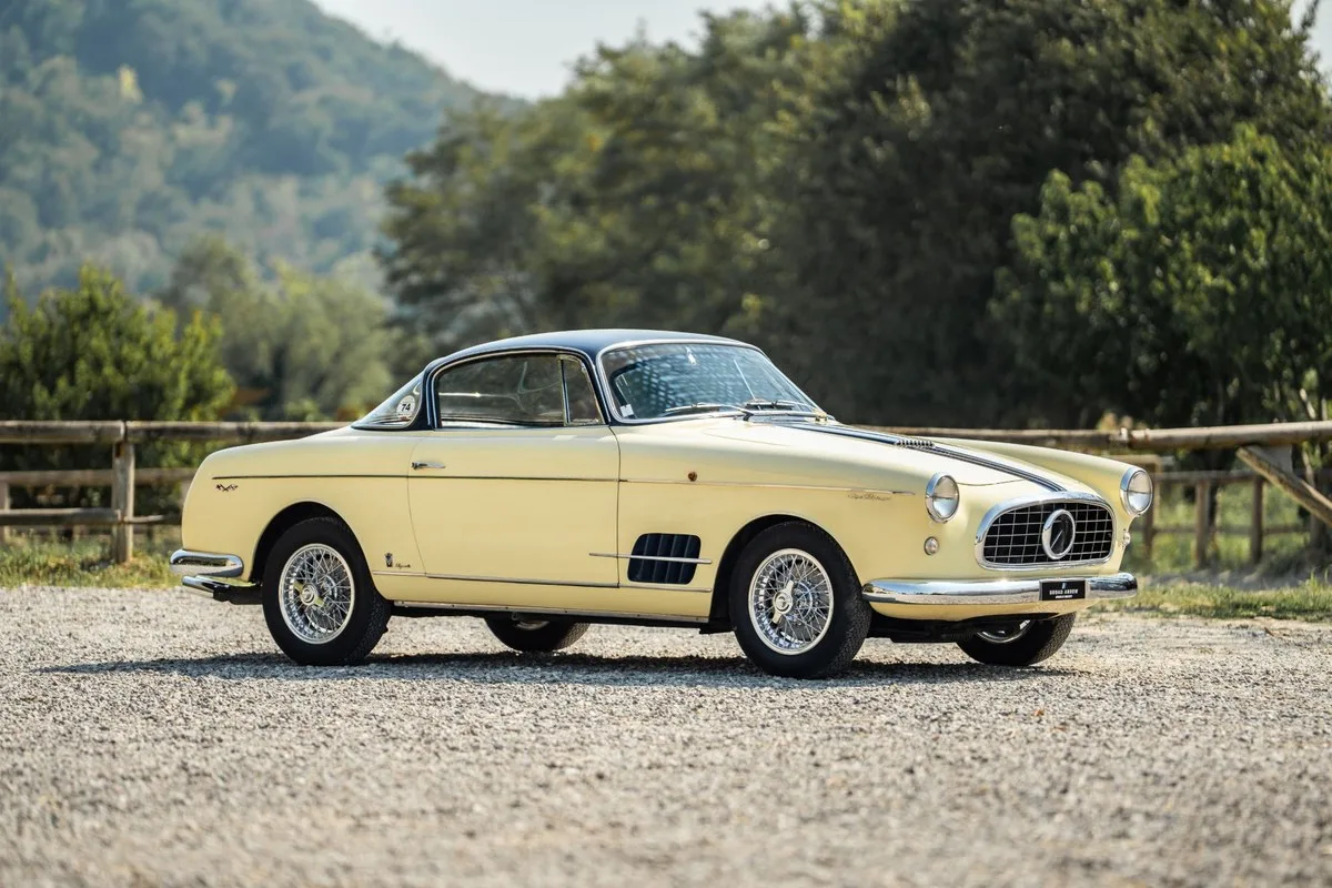 Ivory and dark blue 1957 Fiat 1100 TV Coupé by Vignale on gravel