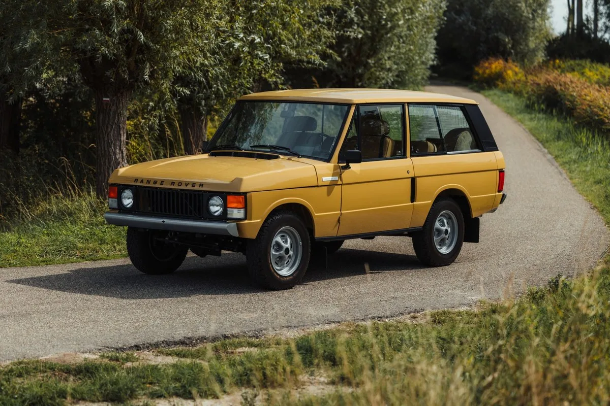 Bahama Gold 1979 three-door Range Rover on a country lane