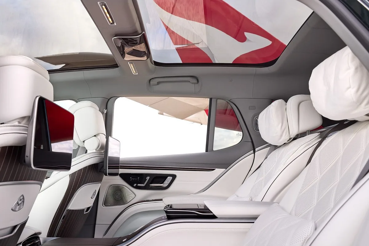 White leather rear cabin of the Mercedes-Maybach EQS SUV with screens and panoramic roof