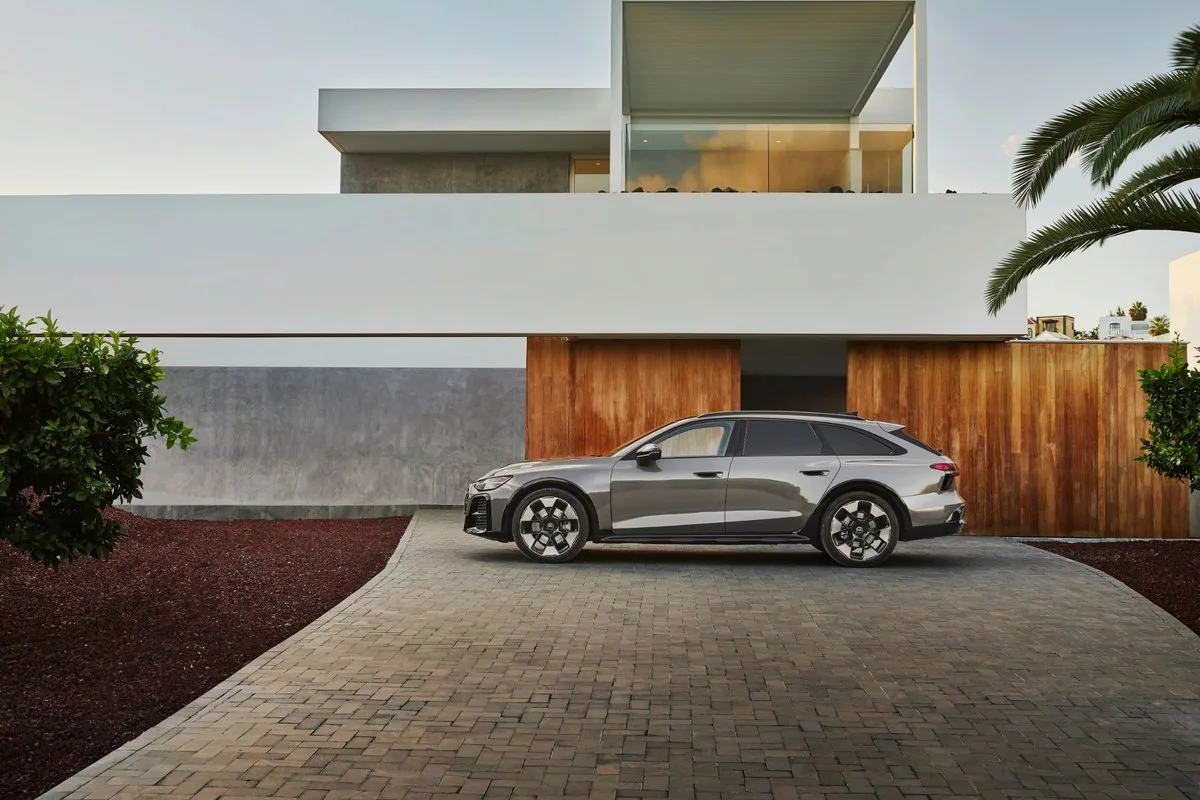 Grey Audi A6 allroad side view on a paved driveway