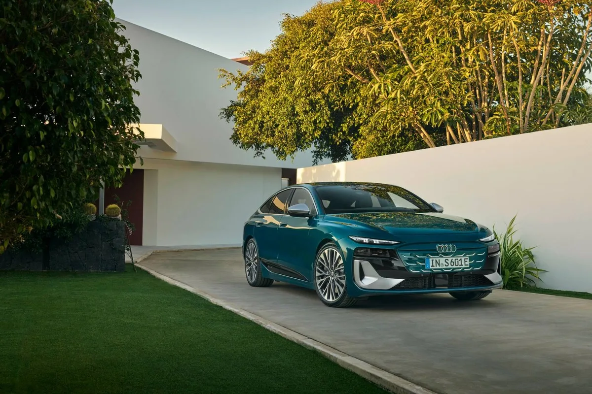 Teal Audi S6 Sportback e-tron front three-quarter view on a driveway