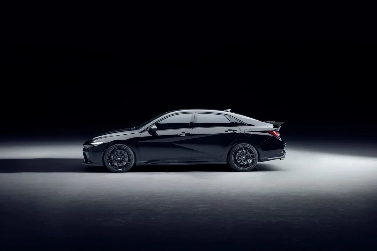 Black Hyundai i30 Sedan N Monochrome side profile with forged wheels and rear spoiler