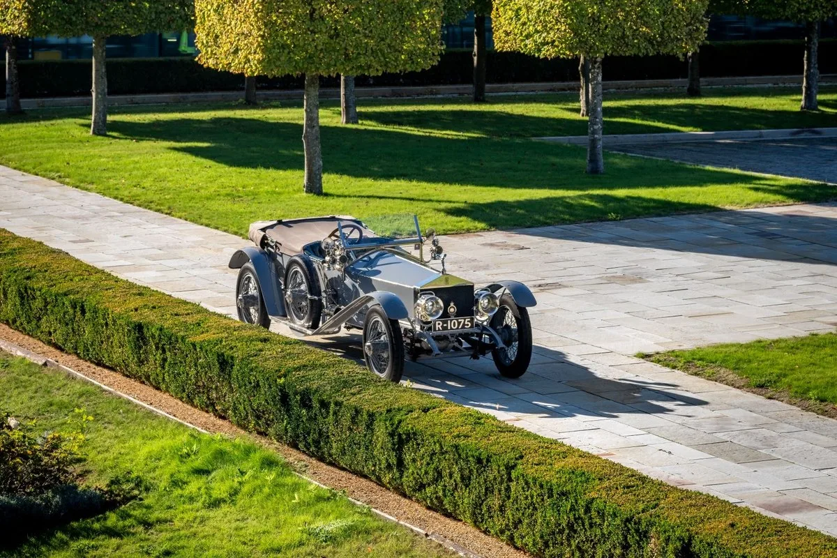 Silver Rolls-Royce Silver Ghost open tourer seen from above beside a hedge