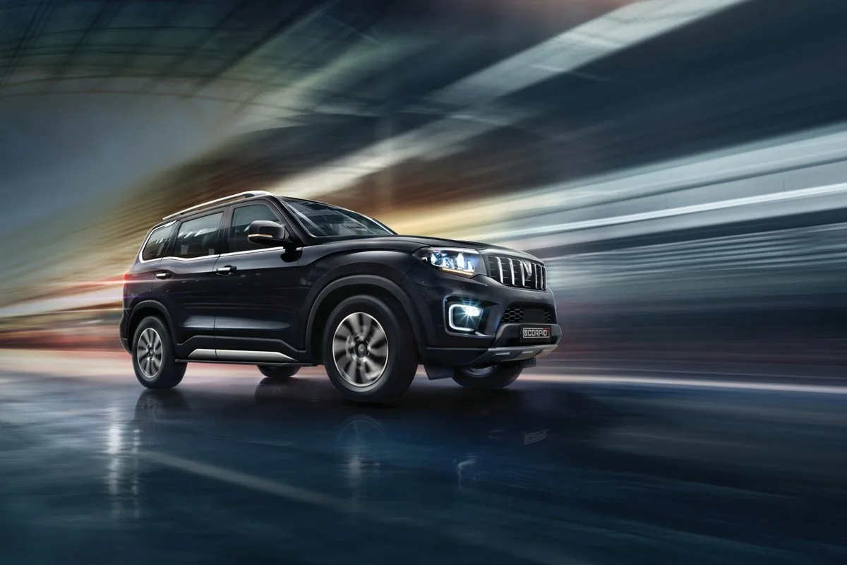 Black Mahindra Scorpio in a studio with light streaks