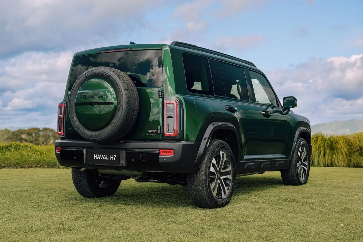 Green Haval H7 Hi4 PHEV rear three-quarter view with tailgate-mounted spare wheel