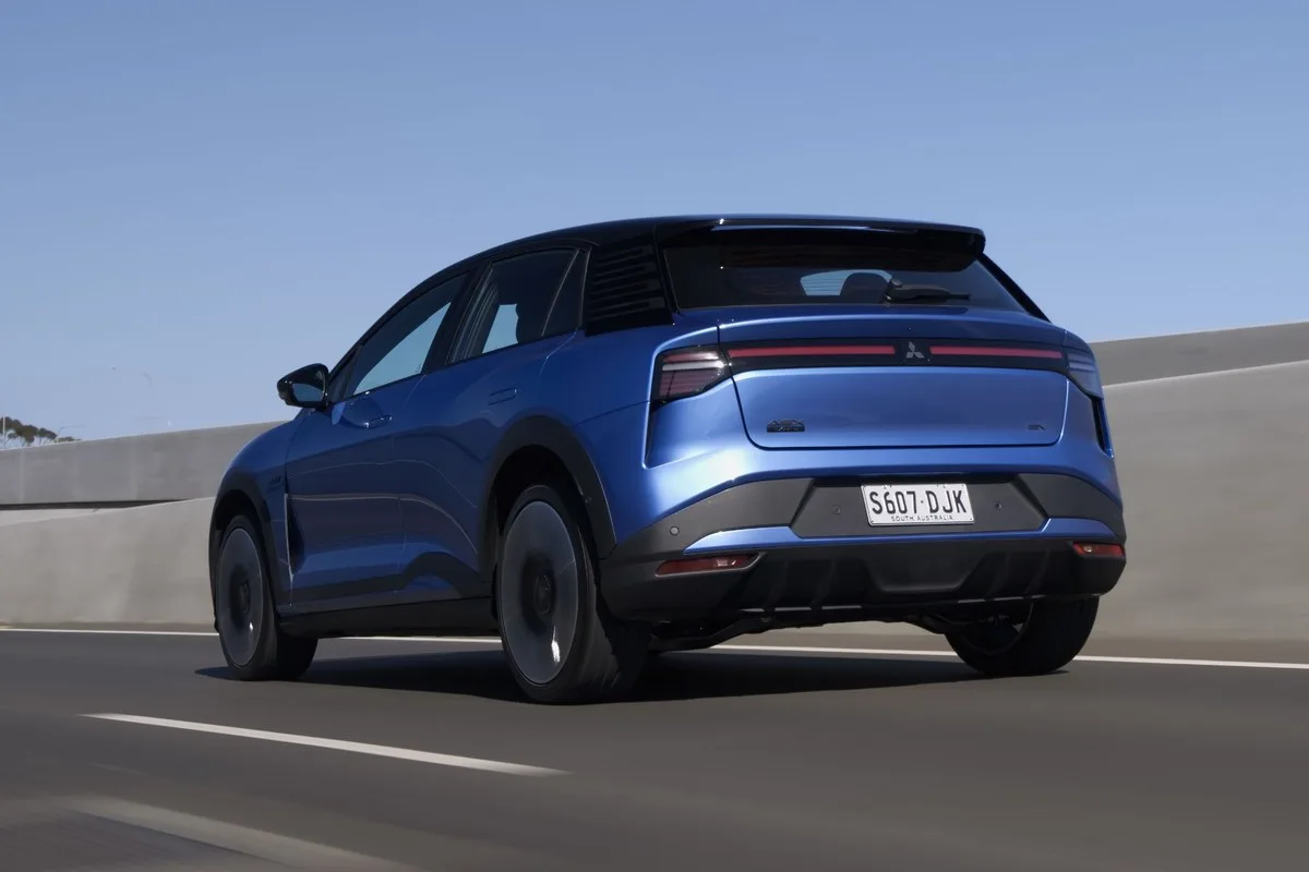 Blue Mitsubishi ASX VR-e with black roof driving on a freeway