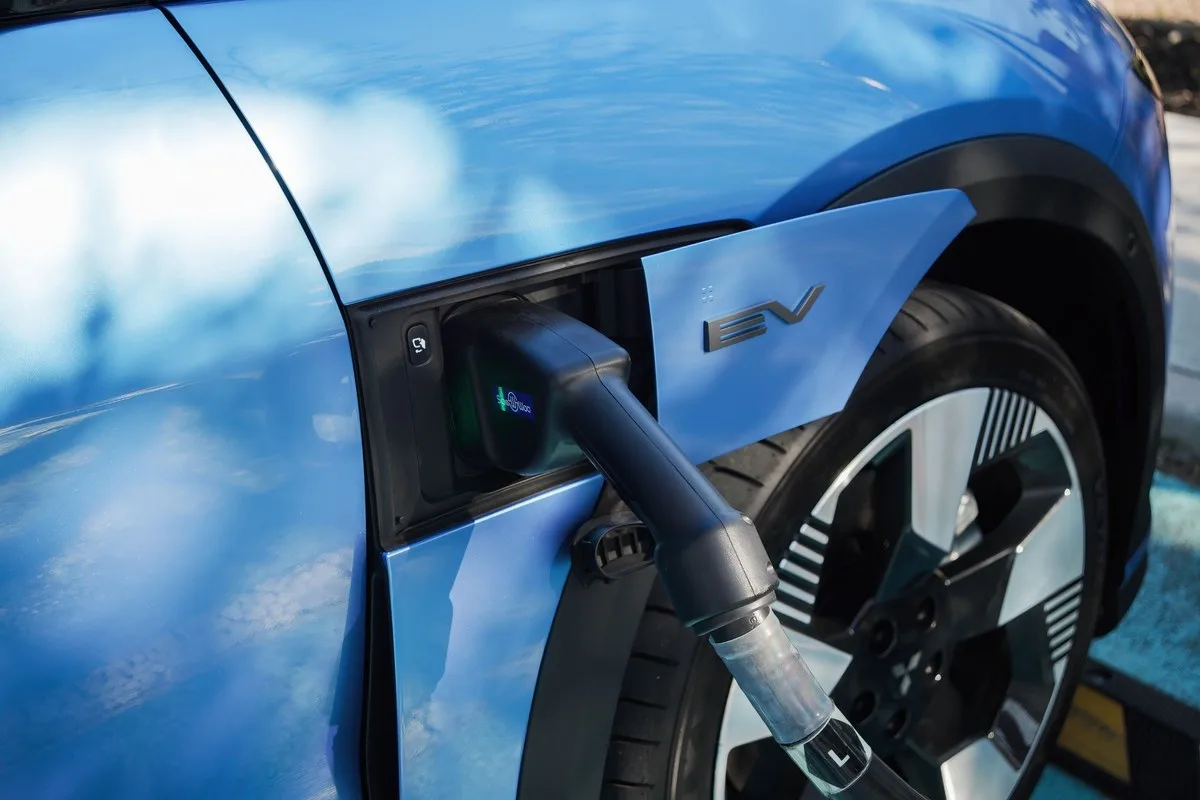 DC fast-charging plug in the front guard port of a blue Mitsubishi ASX VR-e